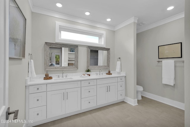 bathroom with vanity, toilet, and ornamental molding