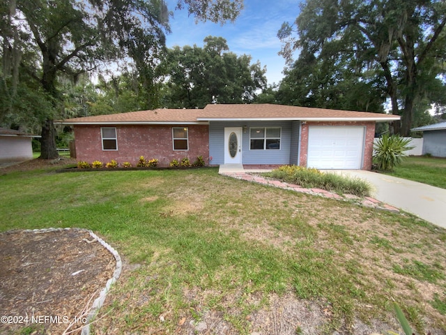 ranch-style home with a front yard and a garage