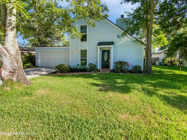 view of front of house featuring a front lawn and a garage