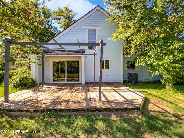 back of house with a deck, a yard, and cooling unit