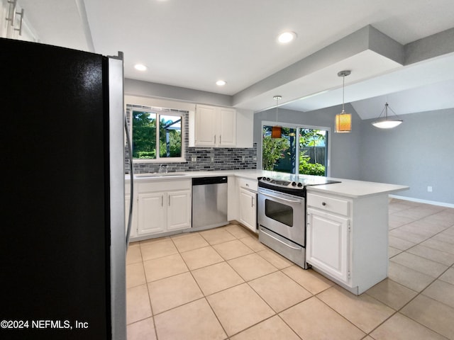 kitchen with hanging light fixtures, stainless steel appliances, white cabinets, backsplash, and kitchen peninsula