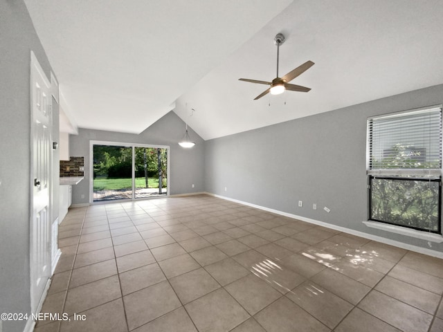 unfurnished living room with tile patterned floors, high vaulted ceiling, and ceiling fan