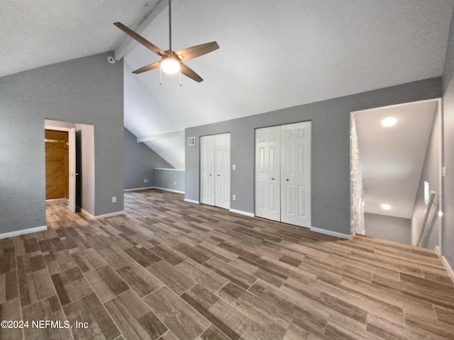 bonus room with ceiling fan, vaulted ceiling with beams, and dark hardwood / wood-style floors