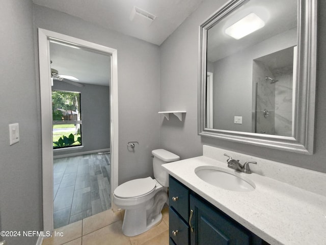 bathroom with toilet, vanity, and walk in shower