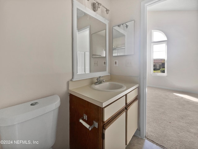 bathroom featuring vanity and toilet