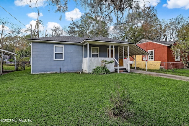 view of front facade with a carport, a porch, and a front yard