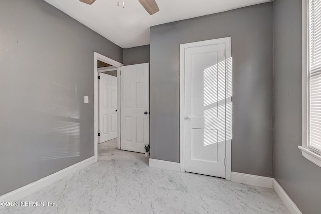 unfurnished bedroom featuring multiple windows and ceiling fan