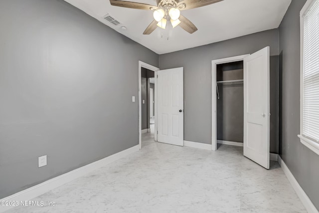 unfurnished bedroom with ceiling fan and a closet