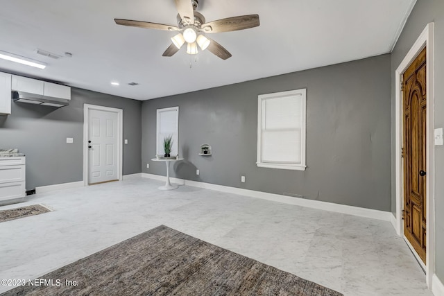 interior space with ceiling fan