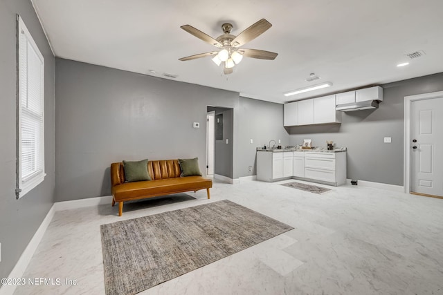 interior space with sink and ceiling fan