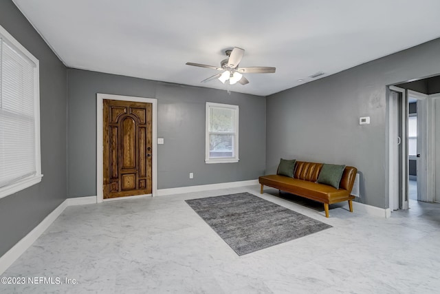 living area featuring ceiling fan