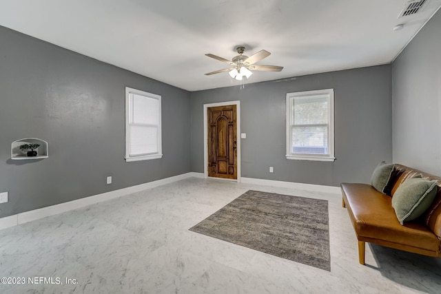 interior space with ceiling fan