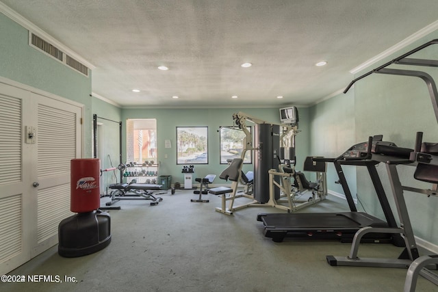 workout area featuring crown molding and a textured ceiling