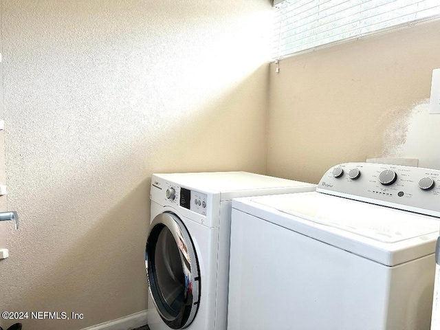 clothes washing area with washing machine and clothes dryer