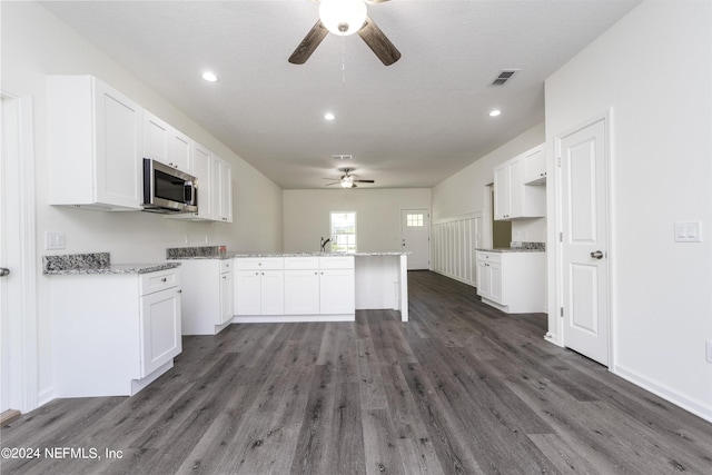 kitchen featuring ceiling fan, dark hardwood / wood-style flooring, sink, white cabinetry, and light stone countertops