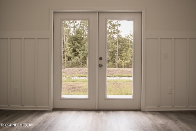 doorway with light wood-type flooring and french doors