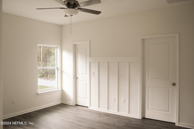 unfurnished bedroom featuring dark wood-type flooring and ceiling fan