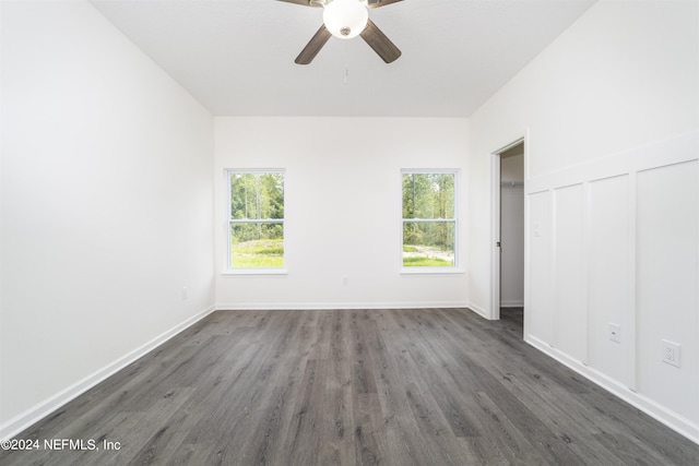 unfurnished bedroom with ceiling fan and dark hardwood / wood-style flooring