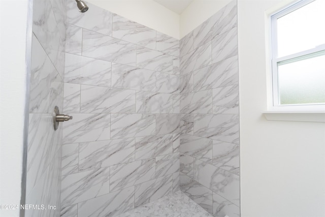 bathroom with a tile shower