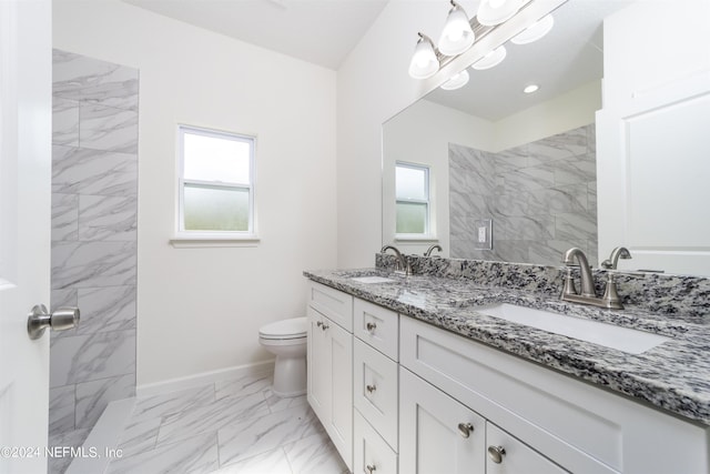 bathroom with vanity, toilet, and plenty of natural light