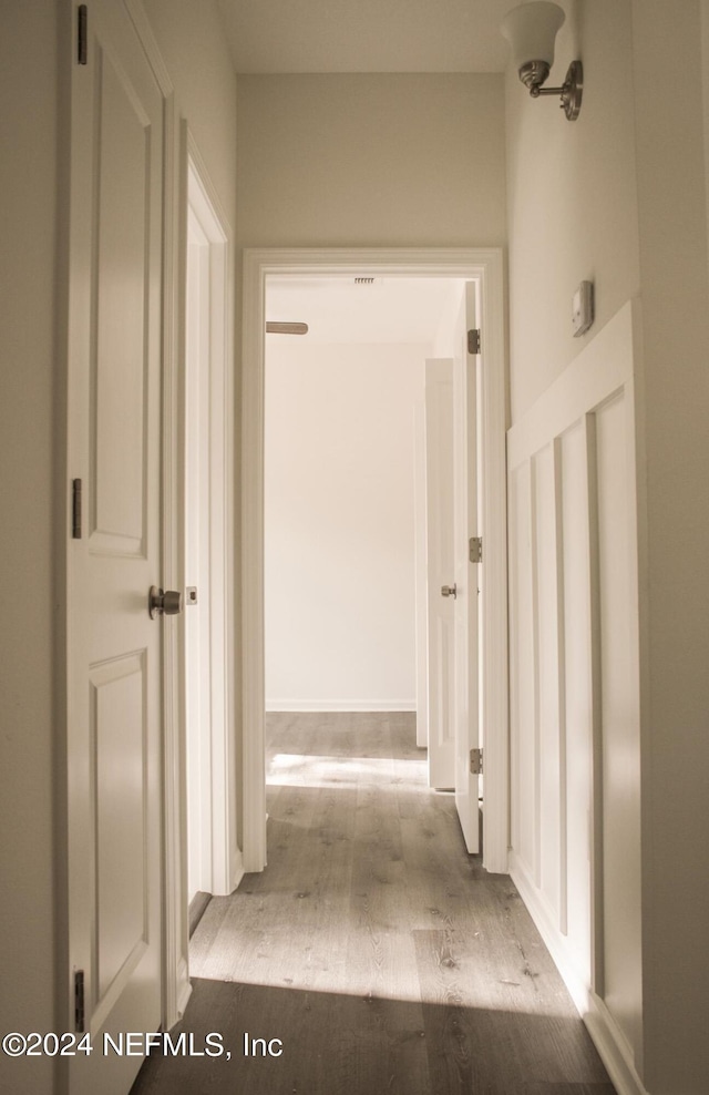 hallway with light hardwood / wood-style floors