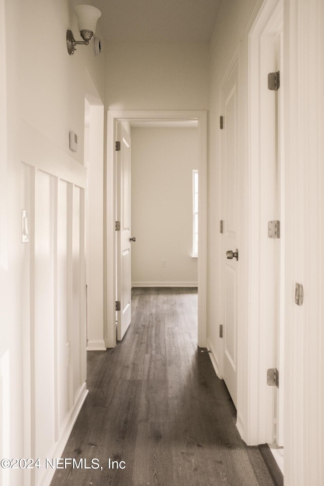 corridor featuring dark wood-type flooring