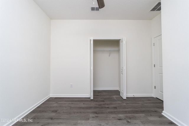 unfurnished bedroom with a closet, ceiling fan, and dark hardwood / wood-style floors