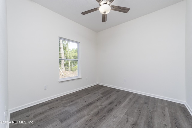 unfurnished room with ceiling fan and dark hardwood / wood-style flooring