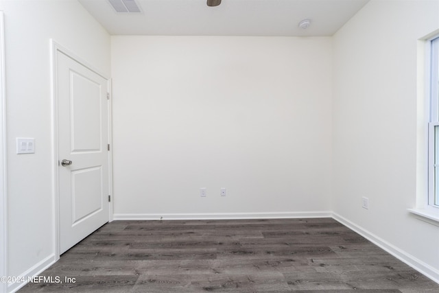 unfurnished room with dark hardwood / wood-style floors