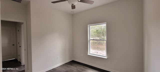 spare room with dark hardwood / wood-style floors and ceiling fan