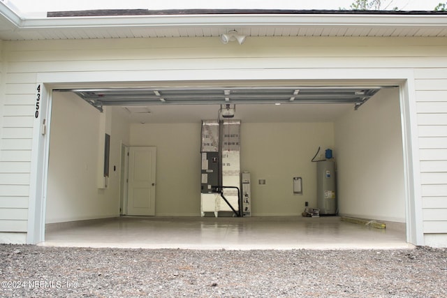 garage with electric water heater and a garage door opener