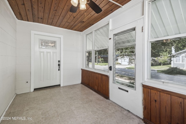 unfurnished sunroom featuring wooden ceiling and ceiling fan