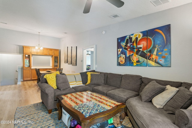 living room featuring light wood-type flooring and ceiling fan