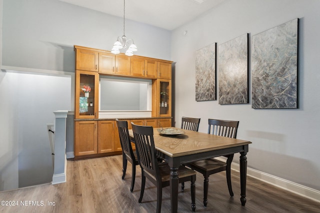 dining area with hardwood / wood-style flooring and a chandelier