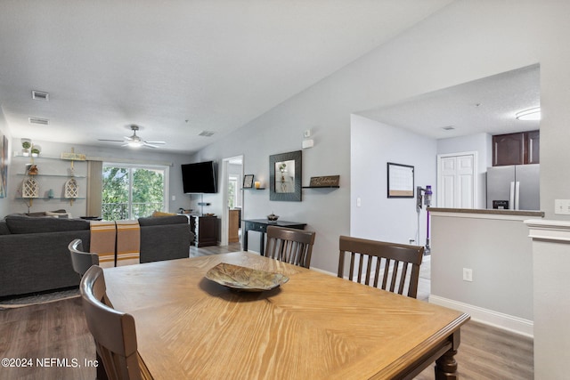 dining area featuring a textured ceiling, hardwood / wood-style floors, and ceiling fan