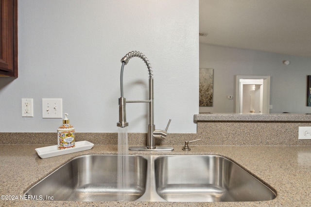 room details featuring light stone counters and sink