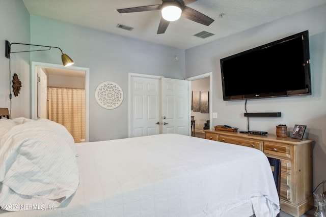 bedroom with ensuite bathroom and ceiling fan