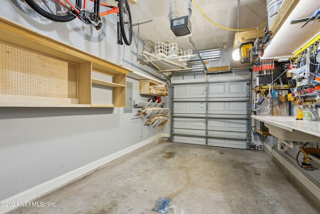 garage with a workshop area and a garage door opener