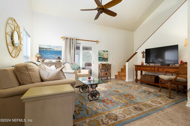 tiled living room featuring high vaulted ceiling and ceiling fan