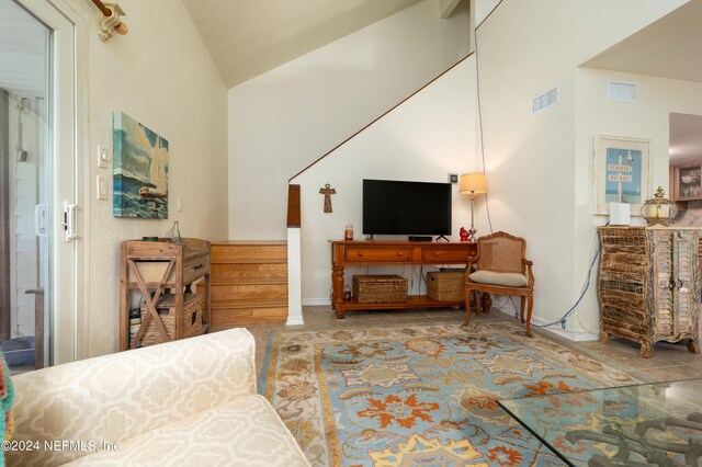 living room with high vaulted ceiling