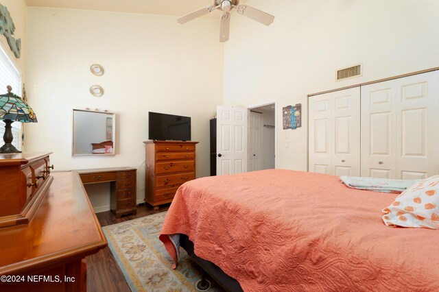 bedroom with high vaulted ceiling, a closet, ceiling fan, and dark hardwood / wood-style floors