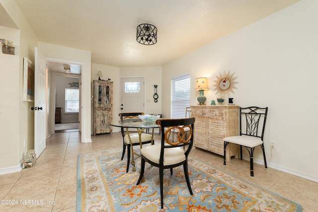 dining space featuring light tile patterned floors and baseboards