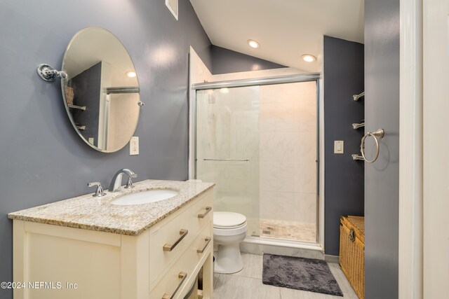 bathroom featuring vanity, an enclosed shower, toilet, and tile patterned floors