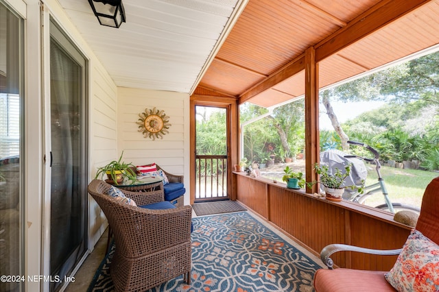 sunroom featuring wooden ceiling and vaulted ceiling