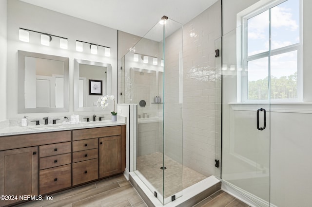 bathroom featuring vanity and a shower with shower door