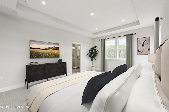 carpeted bedroom with a tray ceiling