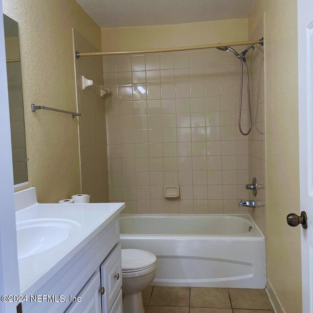 full bathroom featuring tiled shower / bath combo, toilet, tile patterned flooring, and vanity