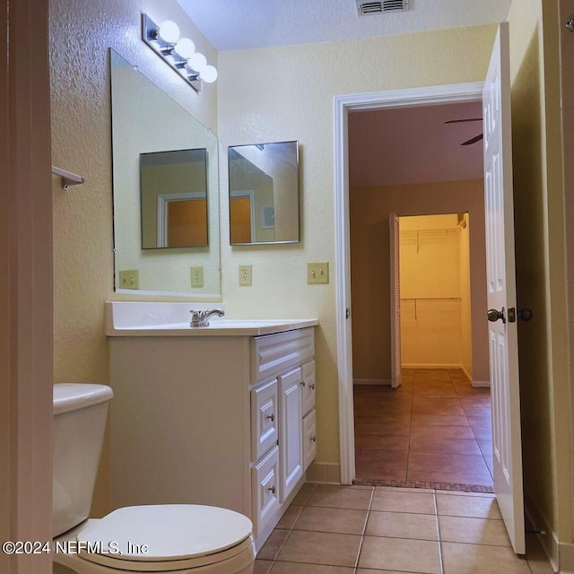 bathroom featuring tile patterned flooring, visible vents, vanity, and toilet