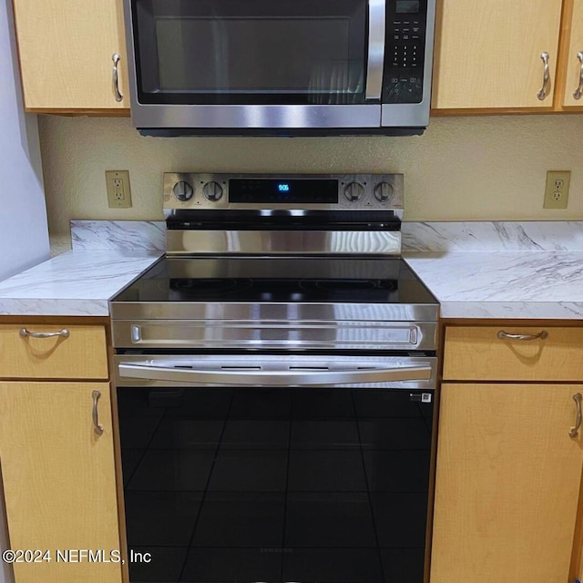 kitchen with appliances with stainless steel finishes and light countertops