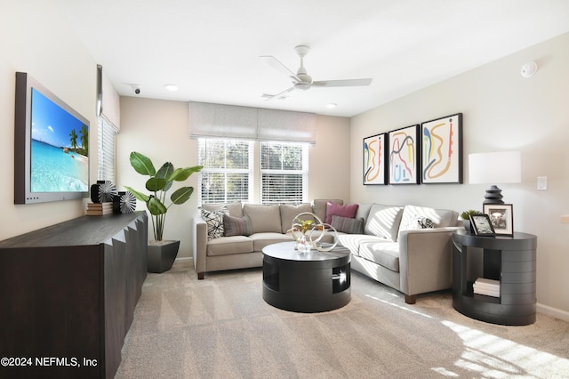 carpeted living room with ceiling fan